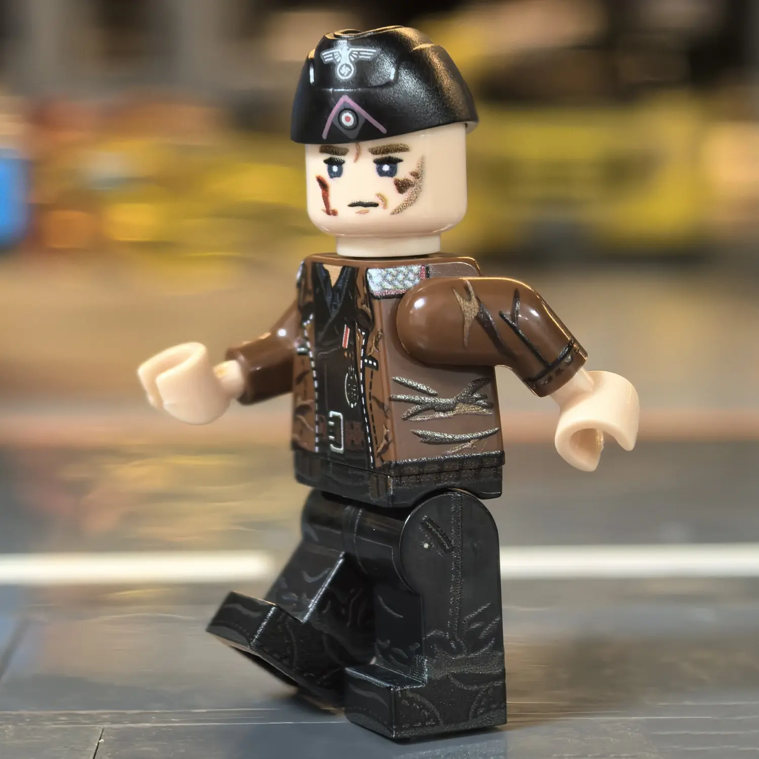 the left side of the Minifigure - German Panzer Commander (Normandy 1944 Hitlerjugend Division Style) WWII (LEGO Compatible)