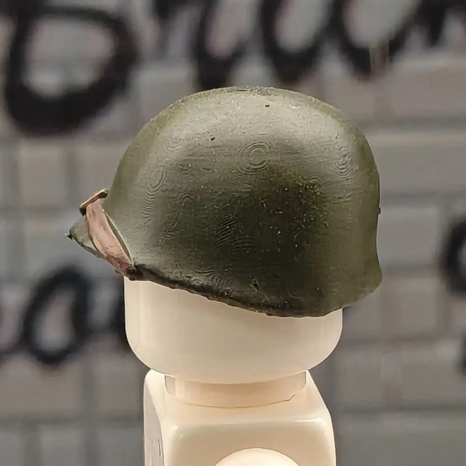 the left side of the Custom Piece Miniature – U.S. Army M1 Helmet dark Olive Drab Green – 3D Print for LEGO minifigure